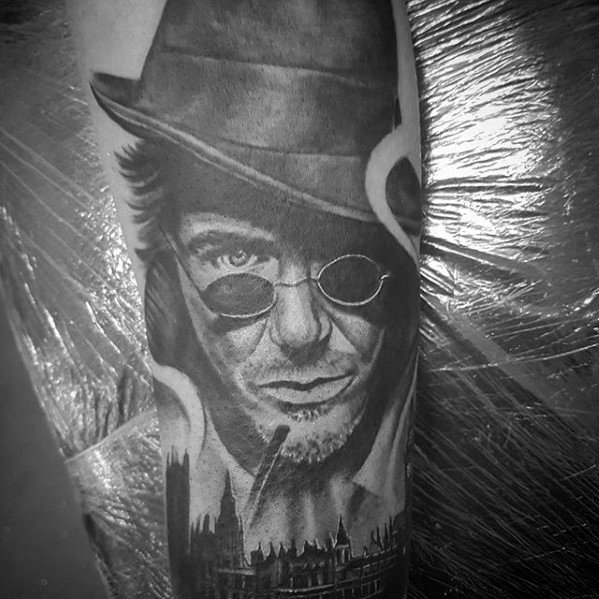 Black and white tattoo of Sherlock Holmes in a hat and sunglasses with a cityscape background