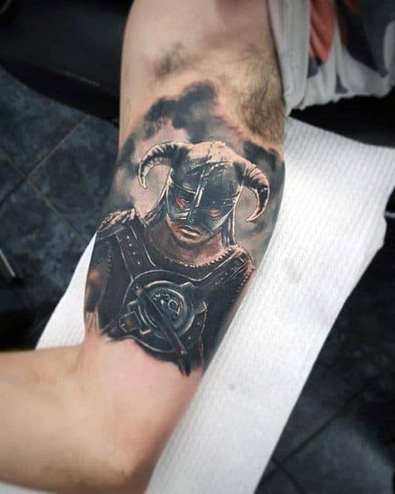 Realistic Skyrim tattoo showcasing the Dragonborn in horned helmet and detailed armor, set against a smoky, dramatic background