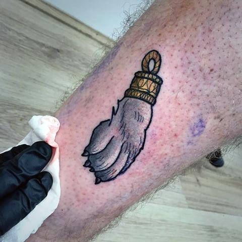 Guy With Small Rabbits Foot Tattoo Design On Leg