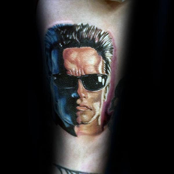 Guy With Small Terminator Arm Tattoo
