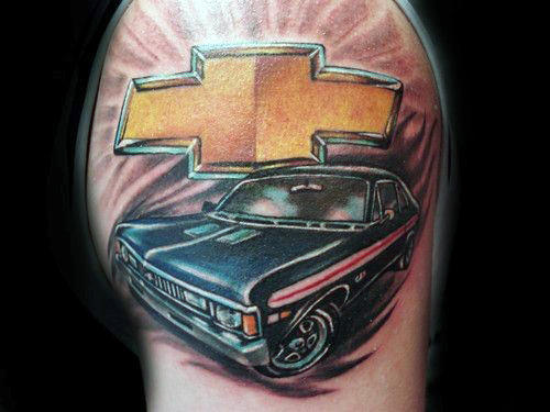 Guy With Sports Car And Gold Chevrolet Logo Tattoo On Upper Arm