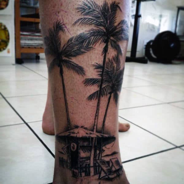 Guy With Straw Hut And Palm Trees Tattoo On Ankles
