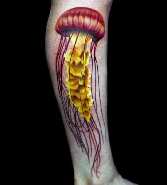 Guy With Sunny Yellow And Red Jellyfish Tattoo On Forearms