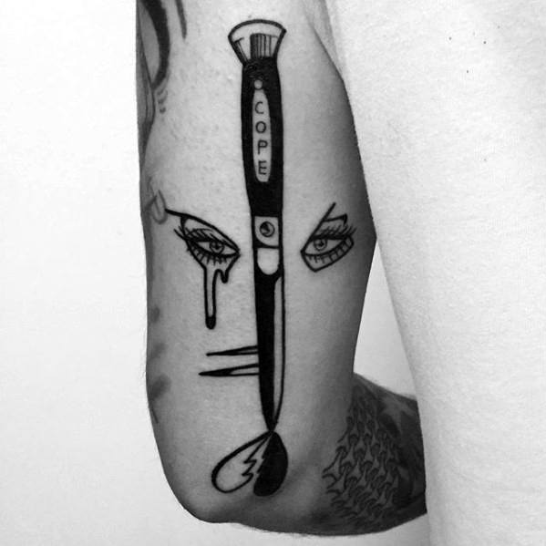 Guy With Switchblade Tattoo Design On Triceps