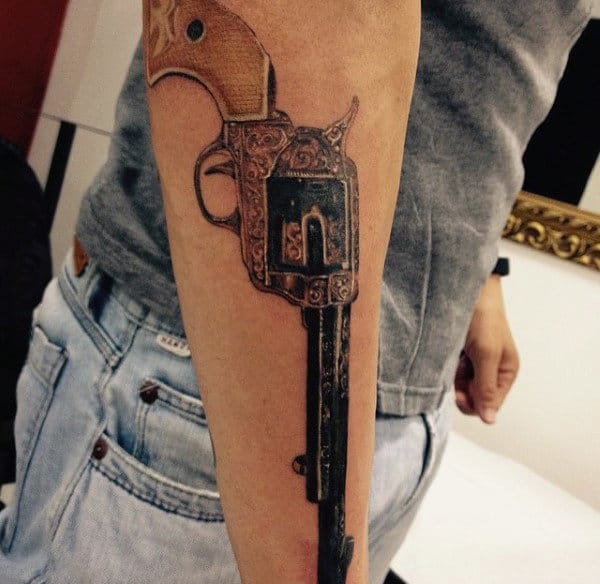 Guy With Terrific Pistol Tattoo On Forearms