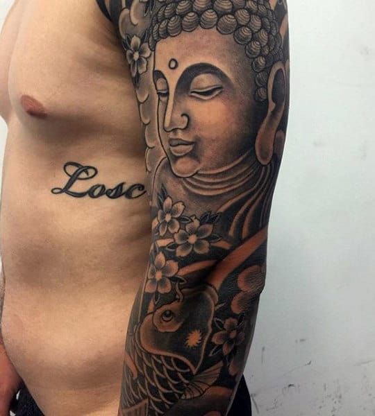 Guy With Traditional Dark Buddhist Tattoo On Arms