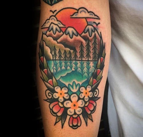 Traditional style tattoo of a mountain lake at sunset, framed with clouds, trees, and bold floral accents at the bottom.