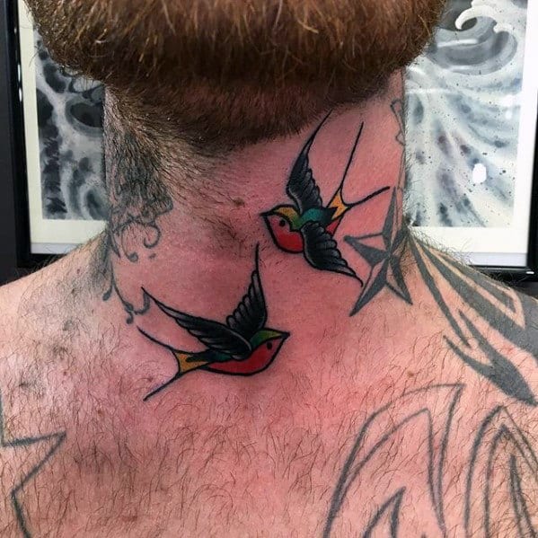 Colorful swallow tattoos on a man's neck with additional black star and other tattoos nearby