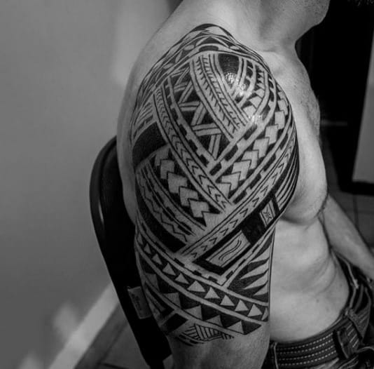 Guy With Upper Arm Tattoo Of Maori Tribal Ink
