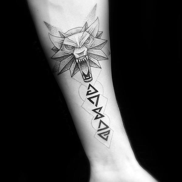 Minimalist Witcher tattoo on the forearm with a snarling wolf medallion and sharp magical sign symbols below in a clean dotwork style.