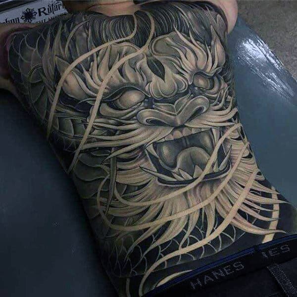 Guy Wtih Squiggly Hairy Demon Face Tattoo Full Back