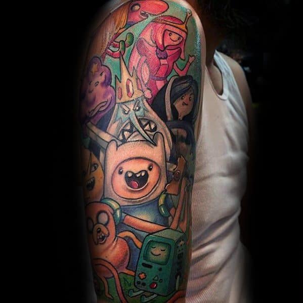 Colorful Adventure Time sleeve tattoo featuring Finn, Jake, BMO, Ice King, Princess Bubblegum, and Marceline in an action-packed design.