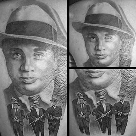 Al Capone tattoo featuring a detailed portrait of the gangster, with an additional scene below showing Capone and his associates in classic gangster attire, holding Tommy guns.
