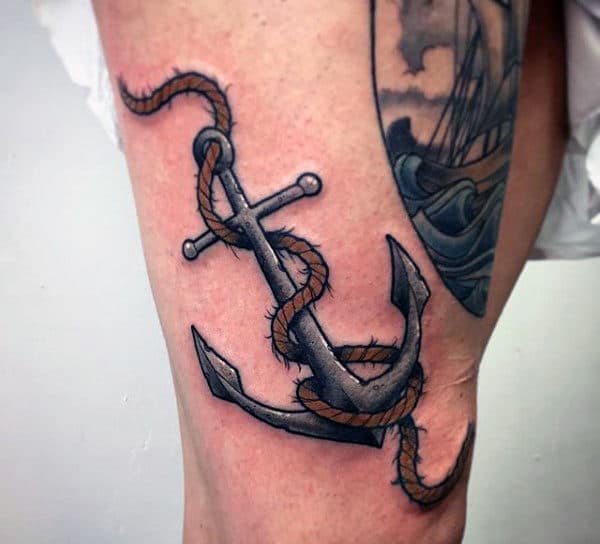 Tattoo of a rope intricately wrapped around a bold anchor on a person's upper thigh