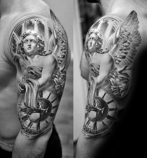 A black and grey tattoo on the upper arm featuring an angel holding a cloth and surrounded by a large clock, with a gothic window design in the background.