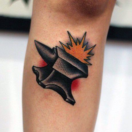 Bold anvil tattoo with sharp black shading and an orange explosion effect on top, set against a red-highlighted background.