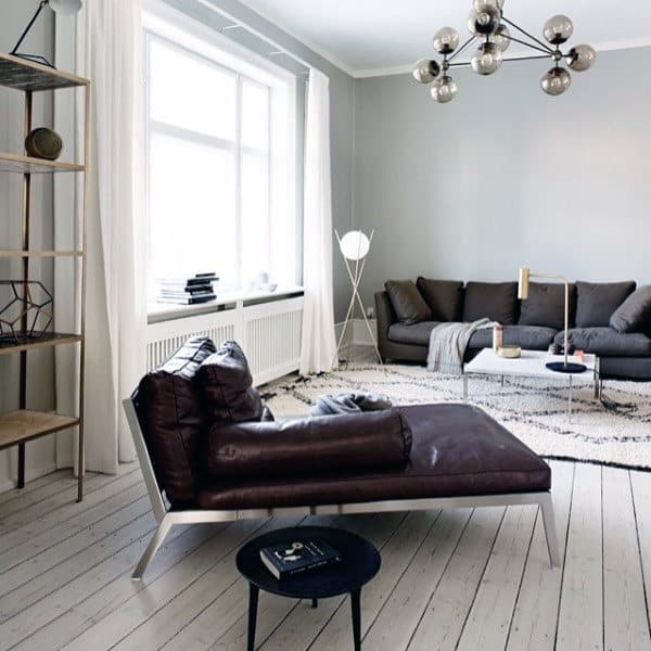 Living room with comfortable leather chaise, gray sofa, and minimalist decor.