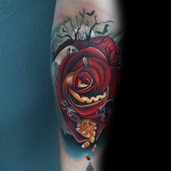 Halloween-themed tattoo featuring a jack-o'-lantern rose and spooky tree background