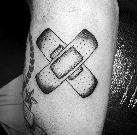 Black and grey dotwork tattoo of two crossed Band-Aids, featuring smooth shading and a clean, minimalist design.