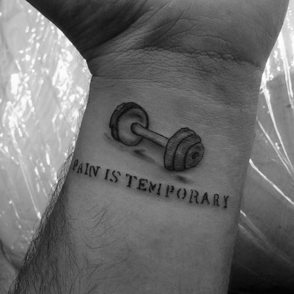 Wrist tattoo of a dumbbell above the phrase “Pain is Temporary,” symbolizing perseverance and mental strength through physical challenges.