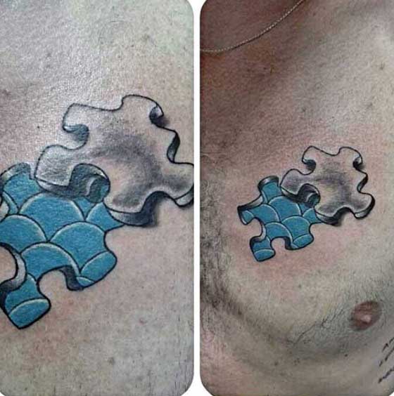 Guys Blue Puzzle Piece Tattoo Of Fish Scales On Chest