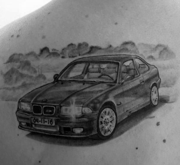 Realistic BMW E36 tattoo on chest, featuring fine details and shading for a bold and dynamic automotive-inspired design.