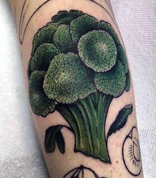 Realistic broccoli tattoo on the forearm, featuring rich green tones, detailed shading, and bold outlines for a vibrant and eye-catching design.