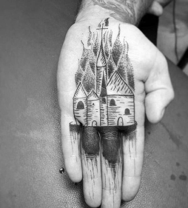 Minimalist burning church tattoo on the palm, with flames rising and building details extending onto the fingers for a bold, raw look.