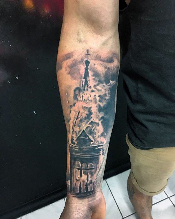Realistic burning church tattoo on the forearm with rising smoke and glowing flames. Dark clouds enhance the dramatic, atmospheric effect.