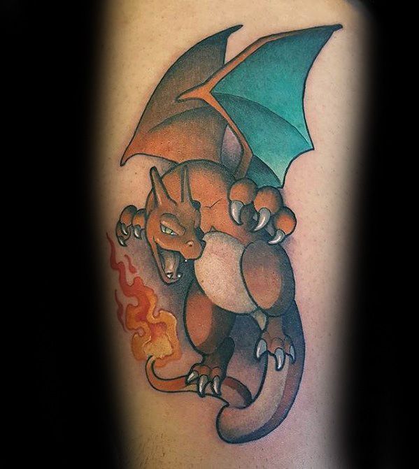 Bold Charizard tattoo with teal wings and vivid fire breath, posed mid-air with detailed shading and a clean color gradient.