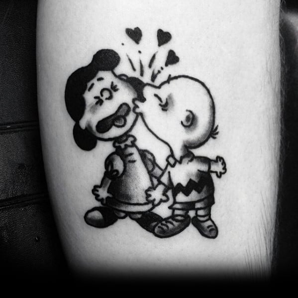 Black and white Charlie Brown and Lucy tattoo, featuring a surprise kiss with hearts above, capturing a playful and nostalgic Peanuts moment.