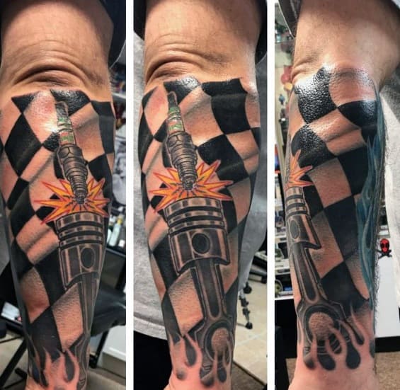 Vibrant racing tattoo featuring a checkered flag, spark plug, and piston with fiery details, symbolizing power, speed, and mechanical passion.