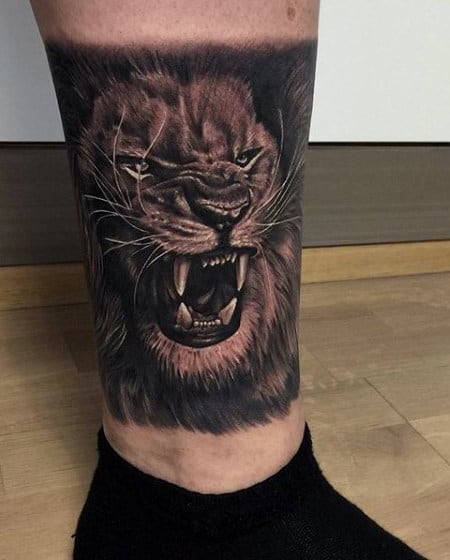 Guy's Chinese Lion Tattoo On Lower Leg