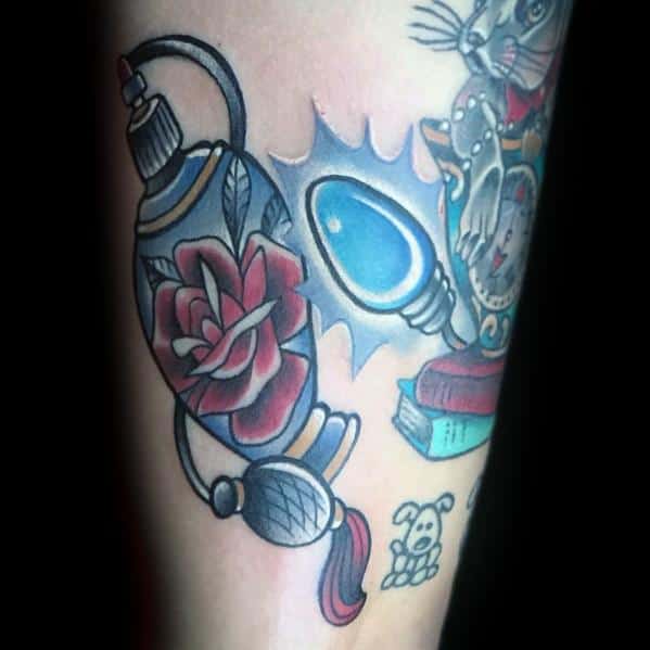 Christmas tattoo featuring a vintage perfume bottle with a red rose design, alongside a glowing blue holiday light bulb, blending elegance with festive charm.