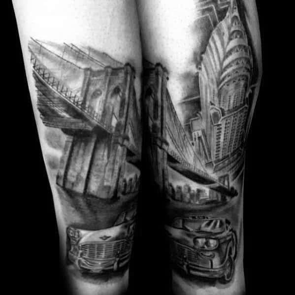 Black-and-grey Chrysler Building tattoo with Brooklyn Bridge and classic cars, creating a bold vintage New York City-inspired design.