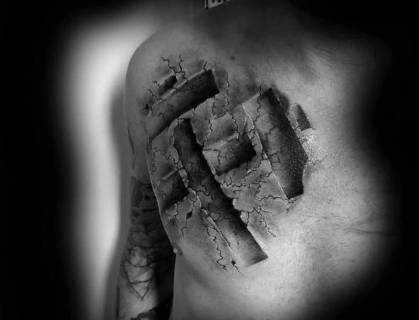 3D-style chest tattoo of a cracked skin effect revealing a raised coal mining pickaxe symbol carved into the flesh.