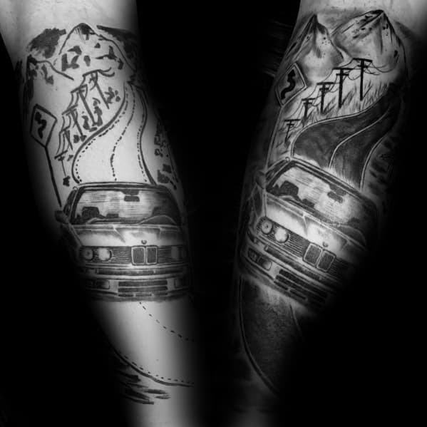 Detailed BMW E30 tattoo on forearm, featuring a winding mountain road and dynamic shading for an adventurous, road-trip-inspired design.