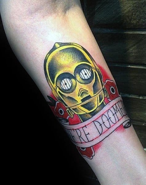 Traditional-style C-3PO tattoo with bold colors, a banner reading "We're Doomed," and red floral accents for a vintage sci-fi aesthetic.
