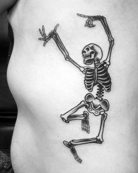 Dancing skeleton tattoo with raised arms and a dynamic pose, featuring bold black ink and fine details for a striking and lively design.