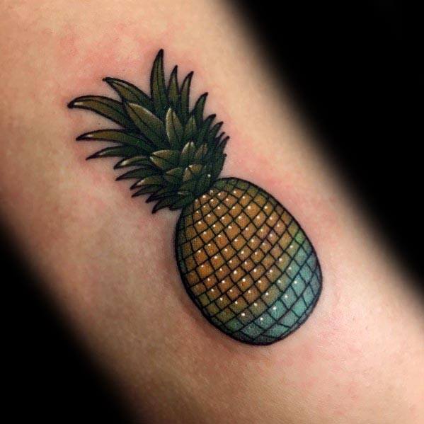 Colorful pineapple tattoo with a disco ball texture, blending tropical and retro aesthetics for a unique and playful design.