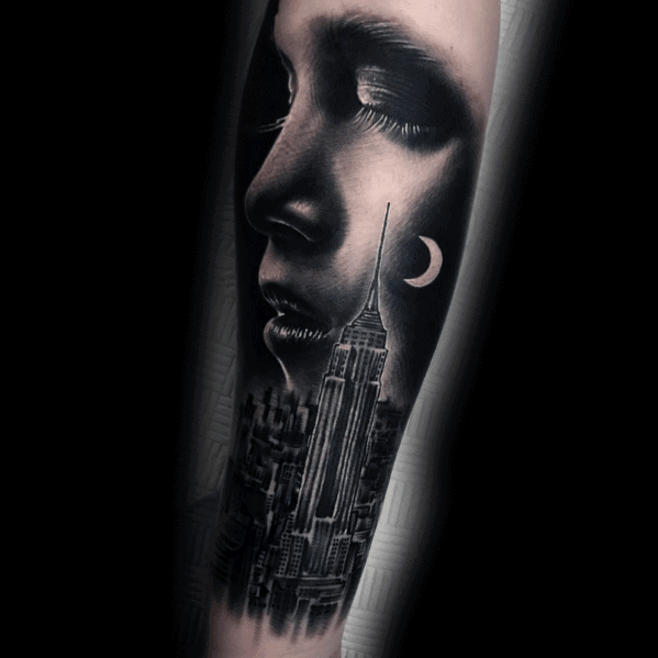 Empire State Building tattoo merging with a serene woman's face under a crescent moon, rendered in stunning black-and-grey realism.