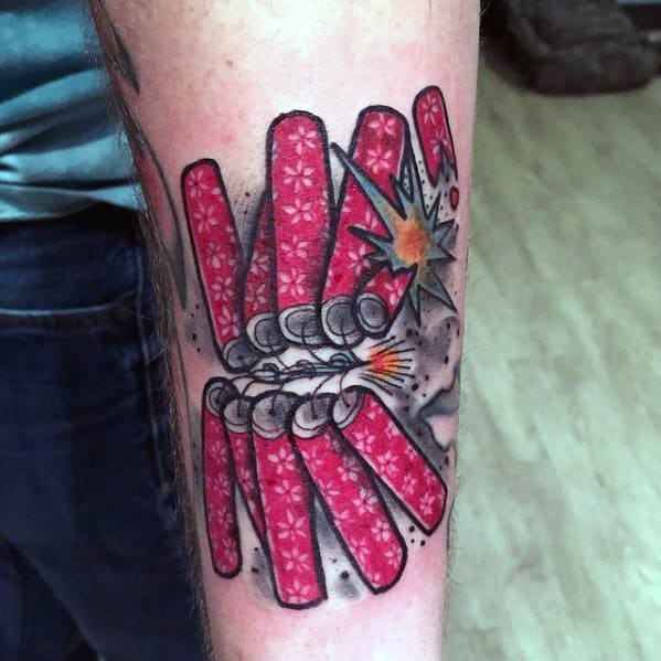 Tattoo of a bundle of red firecrackers with intricate patterns, some exploding with sparks and smoke, creating a bold and dynamic design.