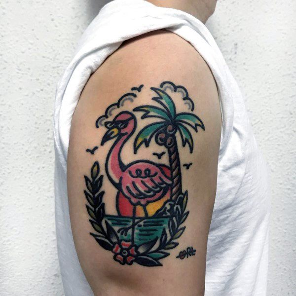 Bold traditional-style flamingo tattoo with palm tree, sunset, and ocean waves, framed by leaves and birds for a tropical vibe.