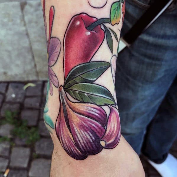Vibrant garlic and chili pepper tattoo with bold colors, smooth shading, and lush green leaves, creating a striking and dynamic botanical design.