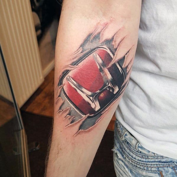 Honda logo tattoo on a man's forearm, designed with a ripped skin effect revealing a bold red and chrome emblem underneath.