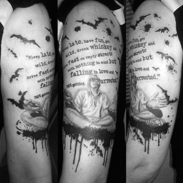 Black and white Hunter S. Thompson tattoo featuring a seated figure, dripping ink effect, bats, and a quote about wild living, whiskey, and adventure.