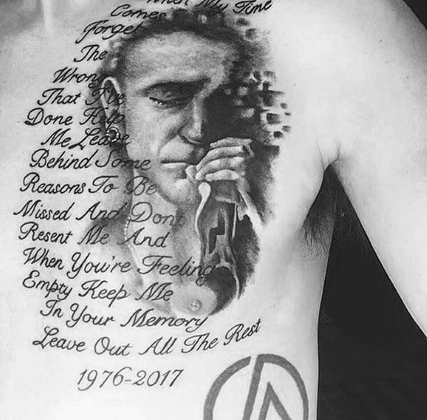 Black and gray chest tattoo of Chester Bennington with 'Leave Out All The Rest' lyrics, his birth and death years, and the Linkin Park logo.