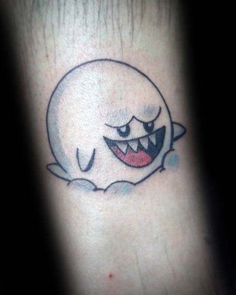 Mario ghost tattoo featuring Boo floating with a mischievous grin, outlined in black with soft shading, inked on the forearm.
