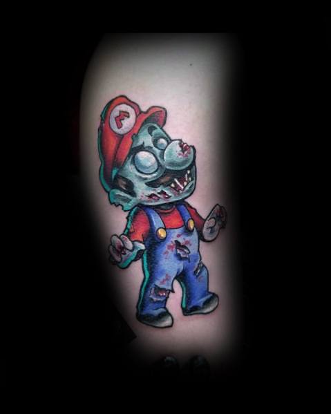 Zombie Mario tattoo with eerie green skin, torn overalls, and glowing eyes, blending classic gaming with a spooky, undead twist.