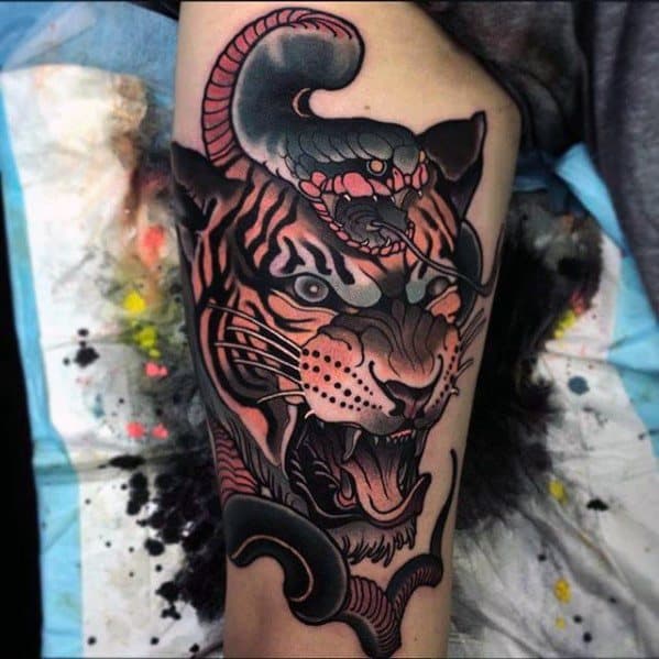 Neo-traditional tattoo of a fierce tiger with a dark, coiled snake slithering over its head, blending bold shading with intense details.